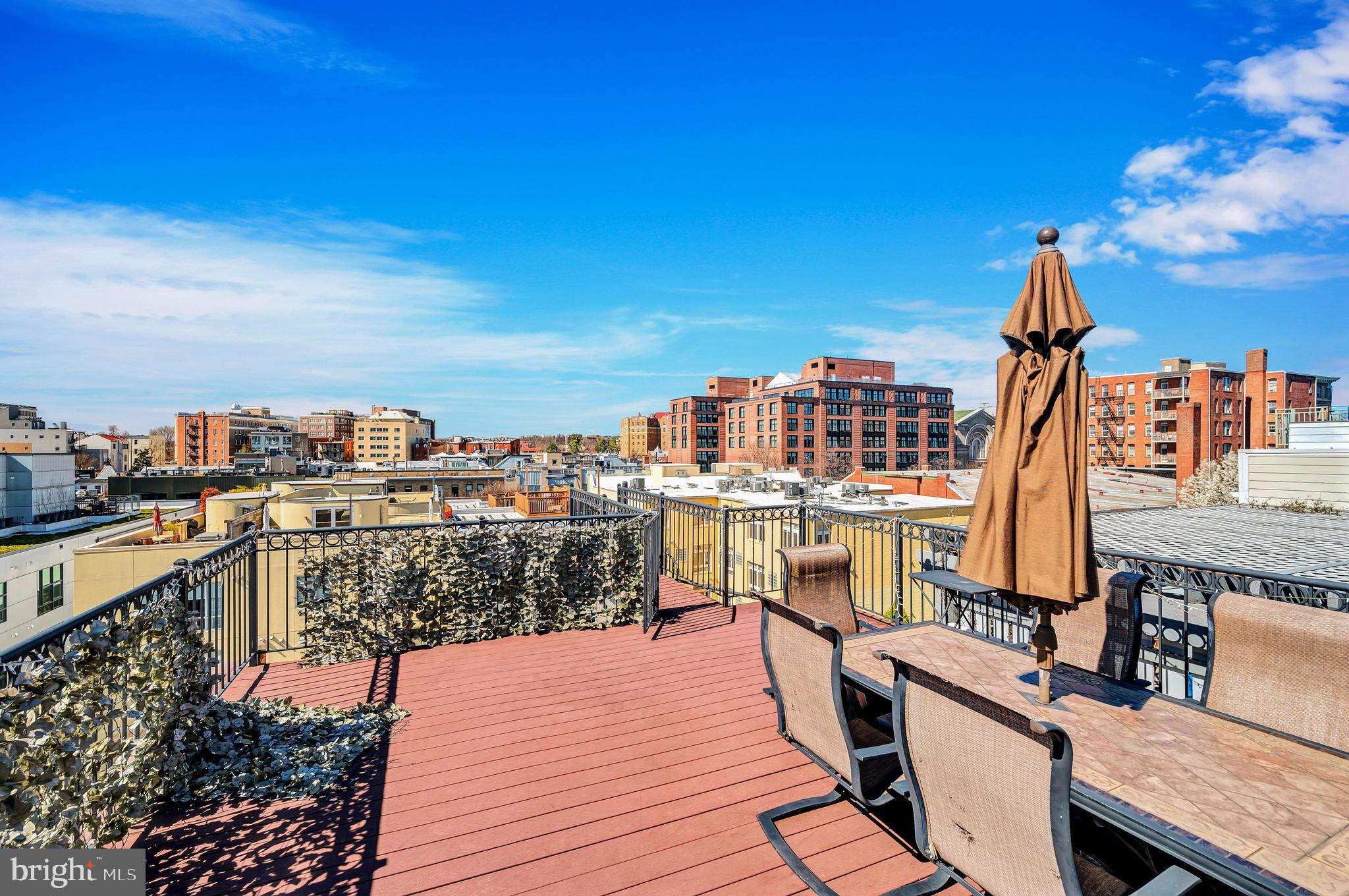 2444 Ontario Road Northwest, Unit 2 Washington, DC 20009 - Photo 24 of 29 a view of a balcony with wooden floor and city view