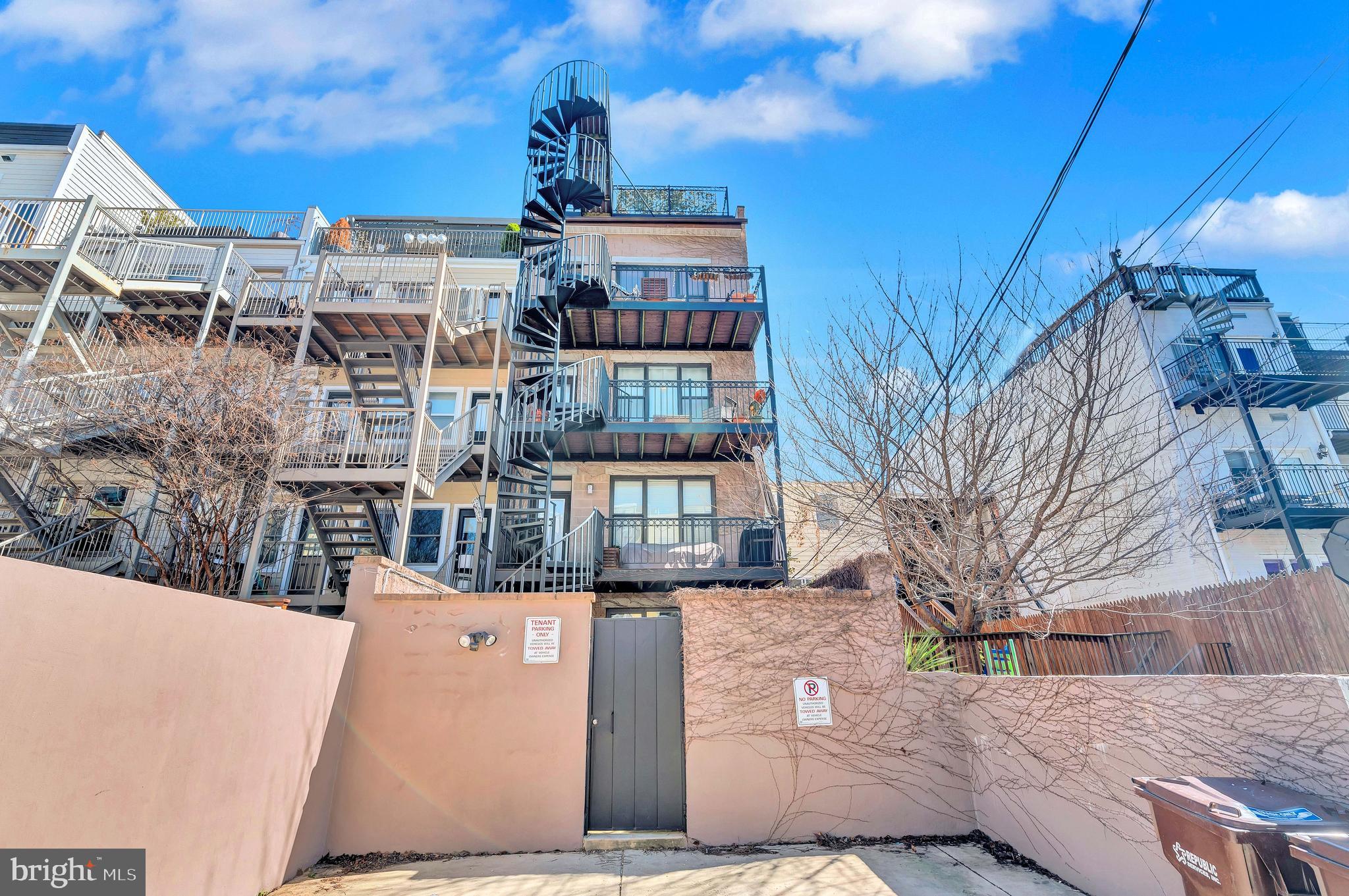 2444 Ontario Road Northwest, Unit 2 Washington, DC 20009 - Photo 26 of 29 a front view of a building with a yard