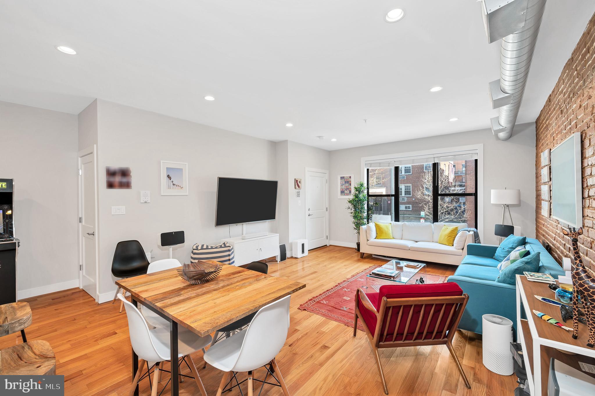 2444 Ontario Road Northwest, Unit 2 Washington, DC 20009 - Photo 4 of 29 a bedroom with a bed and a flat screen tv