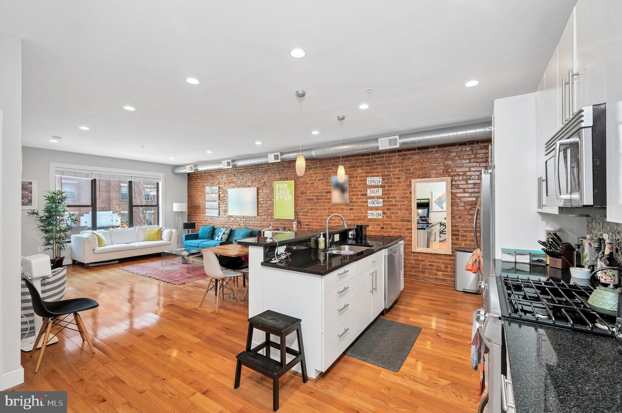 2444 Ontario Road Northwest, Unit 2 Washington, DC 20009 - Photo 7 of 29 a living room with fireplace furniture and a large window