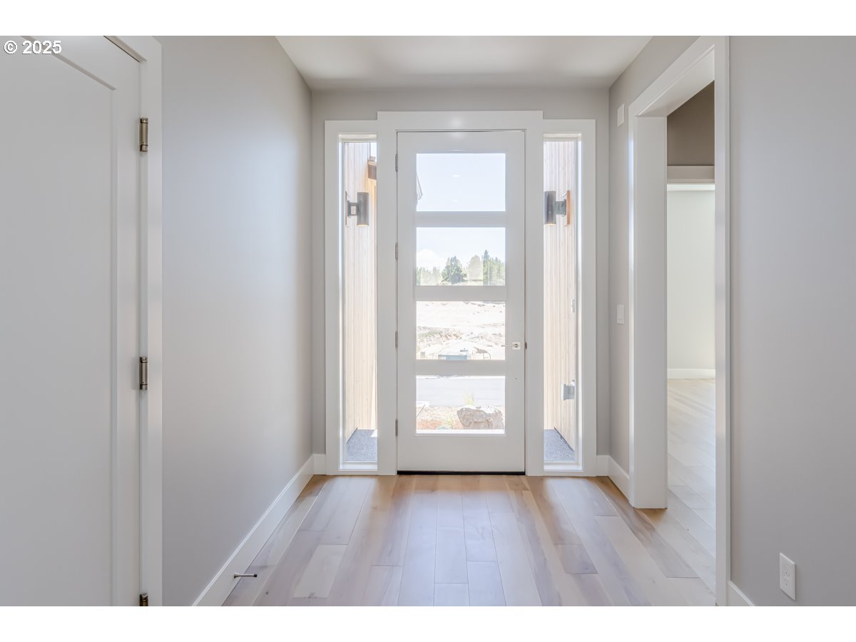 413 Meadows Drive Nehalem, OR 97131 - Photo 11 of 13 a view of an empty room with wooden floor and a window