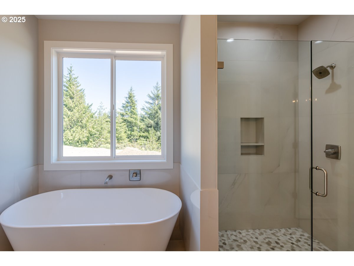 413 Meadows Drive Nehalem, OR 97131 - Photo 13 of 13 a bath tub sitting in a bathroom next to a window