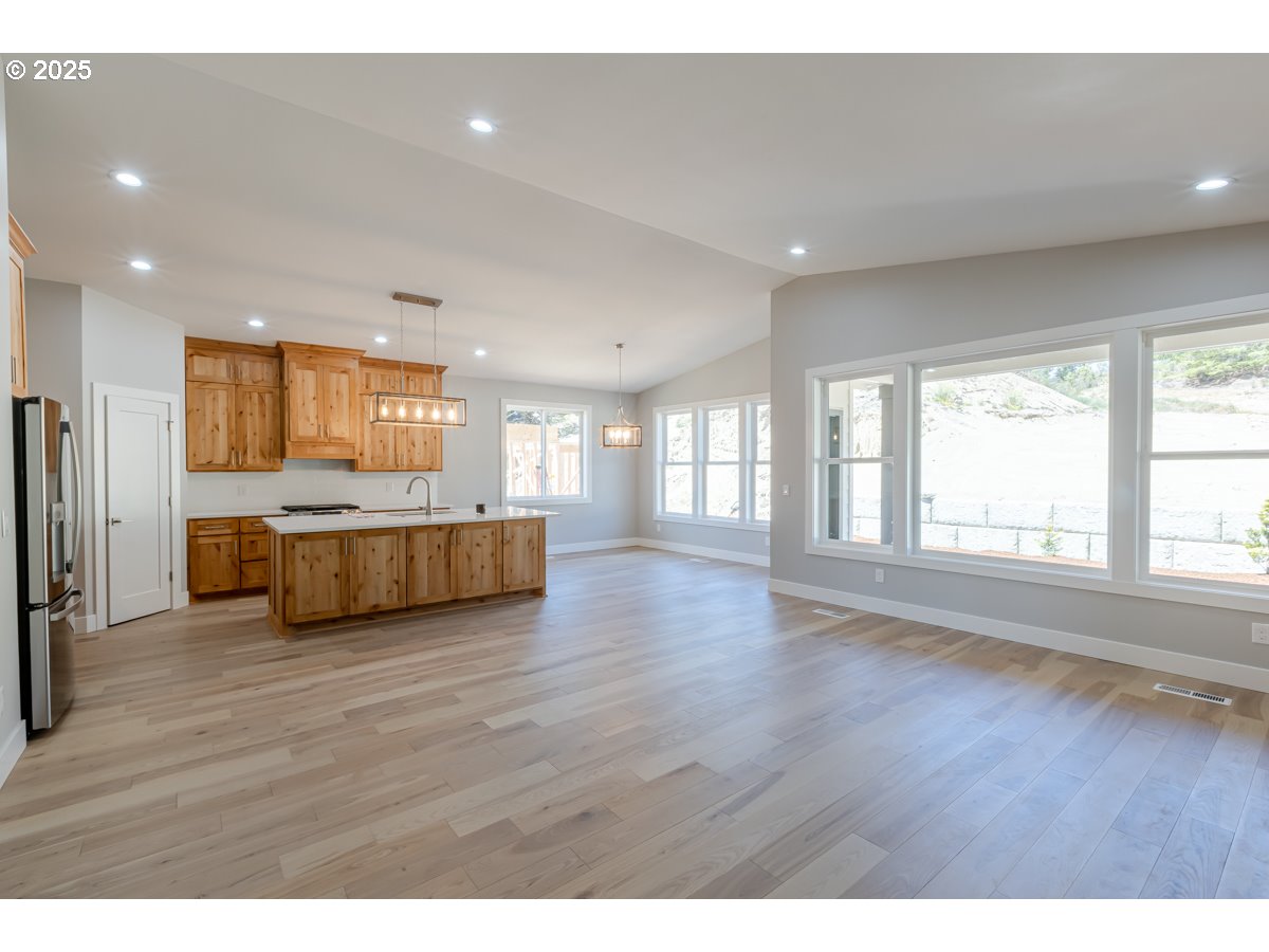 413 Meadows Drive Nehalem, OR 97131 - Photo 6 of 13 a view of a big room with wooden floor and windows