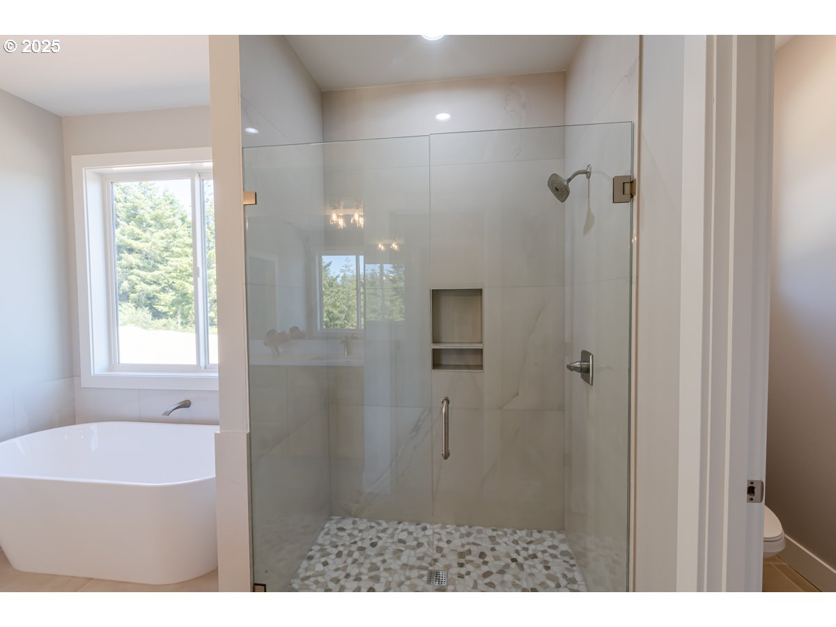 413 Meadows Drive Nehalem, OR 97131 - Photo 9 of 13 a bathroom with a bathtub and shower