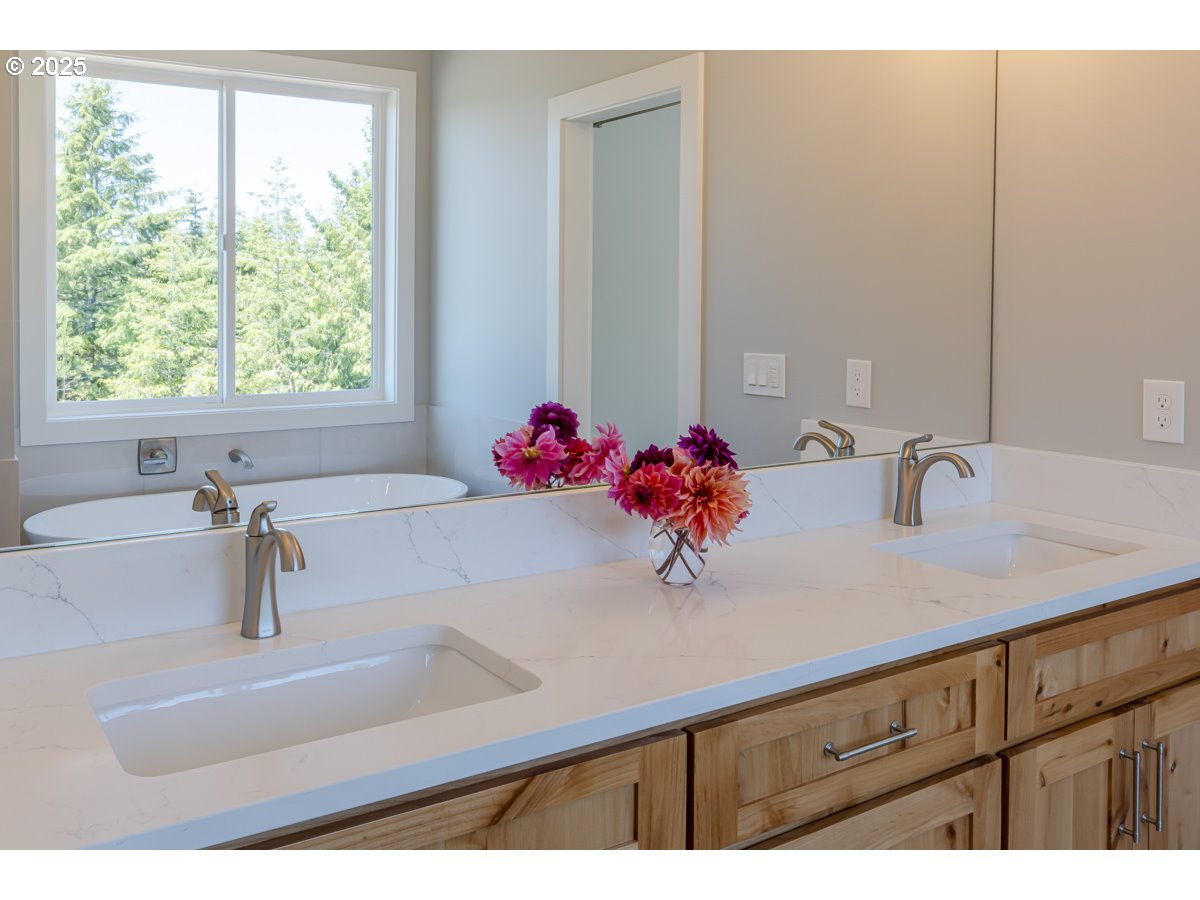 413 Meadows Drive Nehalem, OR 97131 - Photo 10 of 13 a bathroom with a sink and a large mirror