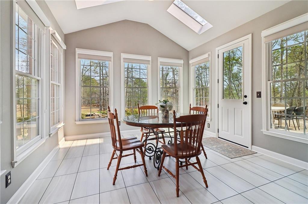 5840 Masters Club Drive Suwanee, GA 30024 - Photo 12 of 72 a view of a dining room with furniture large windows and wooden floor