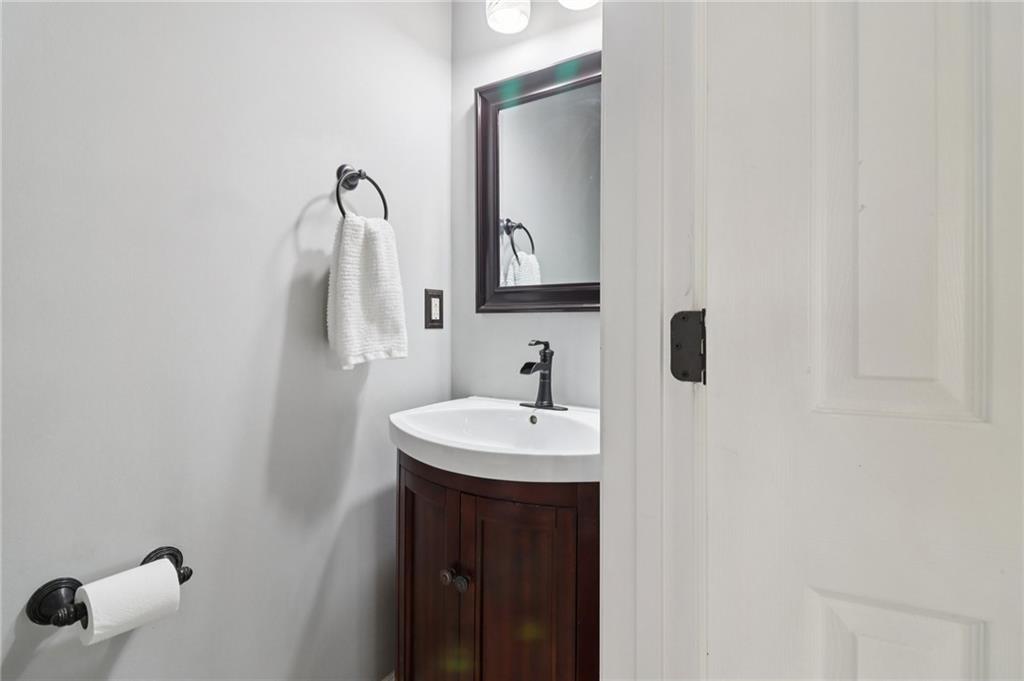 5840 Masters Club Drive Suwanee, GA 30024 - Photo 31 of 72 a bathroom with a sink and a mirror