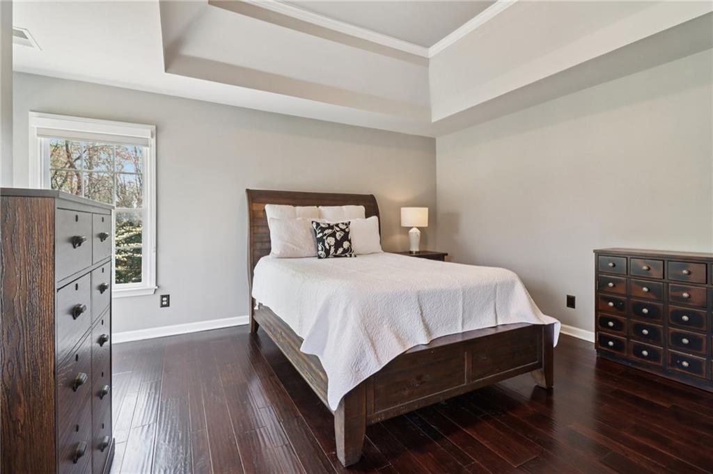 5840 Masters Club Drive Suwanee, GA 30024 - Photo 33 of 72 a bedroom with a bed and a dresser