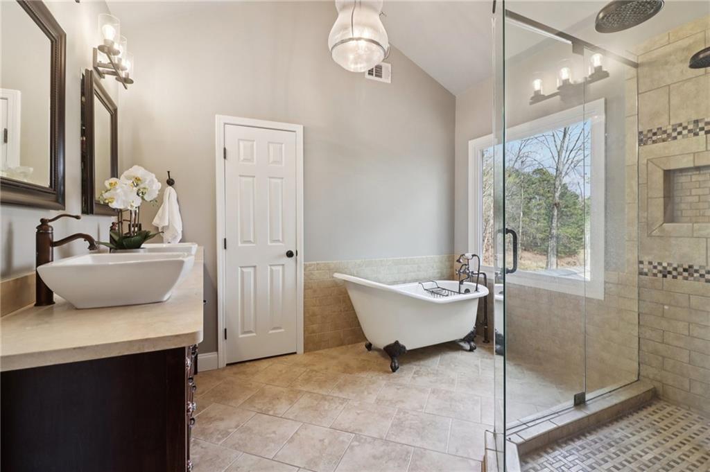5840 Masters Club Drive Suwanee, GA 30024 - Photo 34 of 72 a bathroom with a sink toilet a mirror and shower