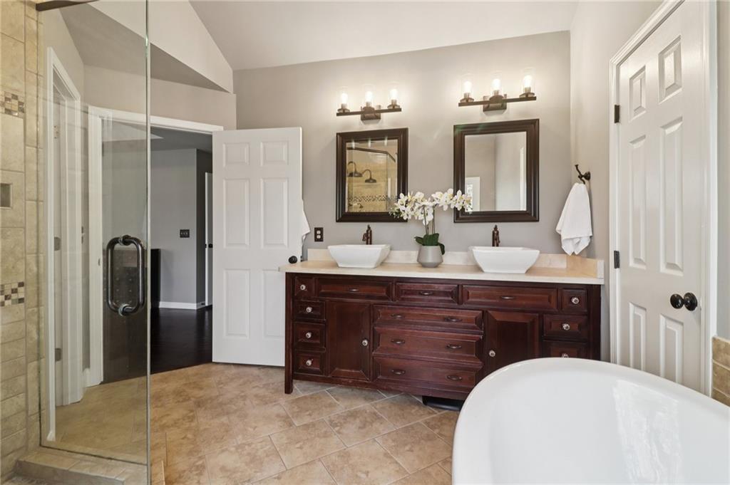 5840 Masters Club Drive Suwanee, GA 30024 - Photo 37 of 72 a bathroom with a sink vanity granite tub and shower