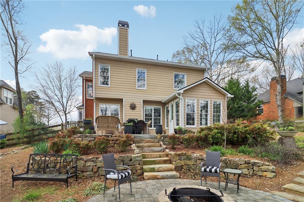 5840 Masters Club Drive Suwanee, GA 30024 - Photo 4 of 72 a front view of a house with garden and patio