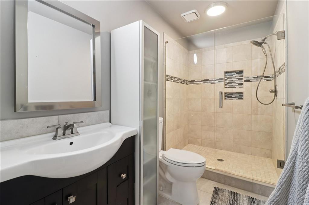 5840 Masters Club Drive Suwanee, GA 30024 - Photo 42 of 72 a bathroom with a sink toilet and shower