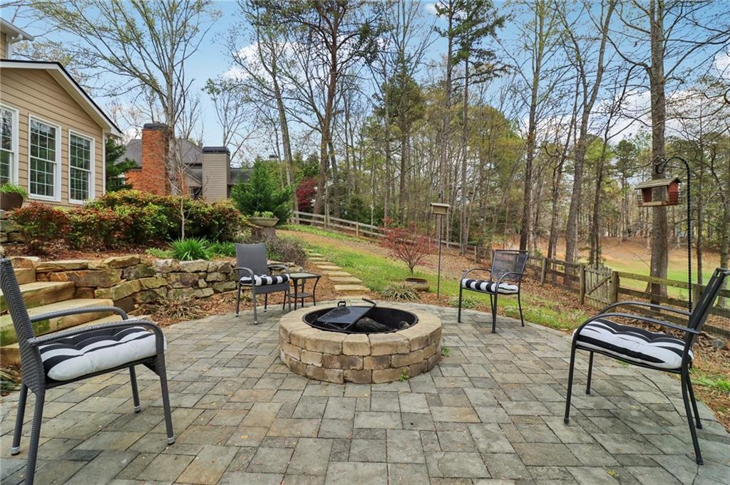 5840 Masters Club Drive Suwanee, GA 30024 - Photo 52 of 72 a view of a backyard with sitting area and fire pit