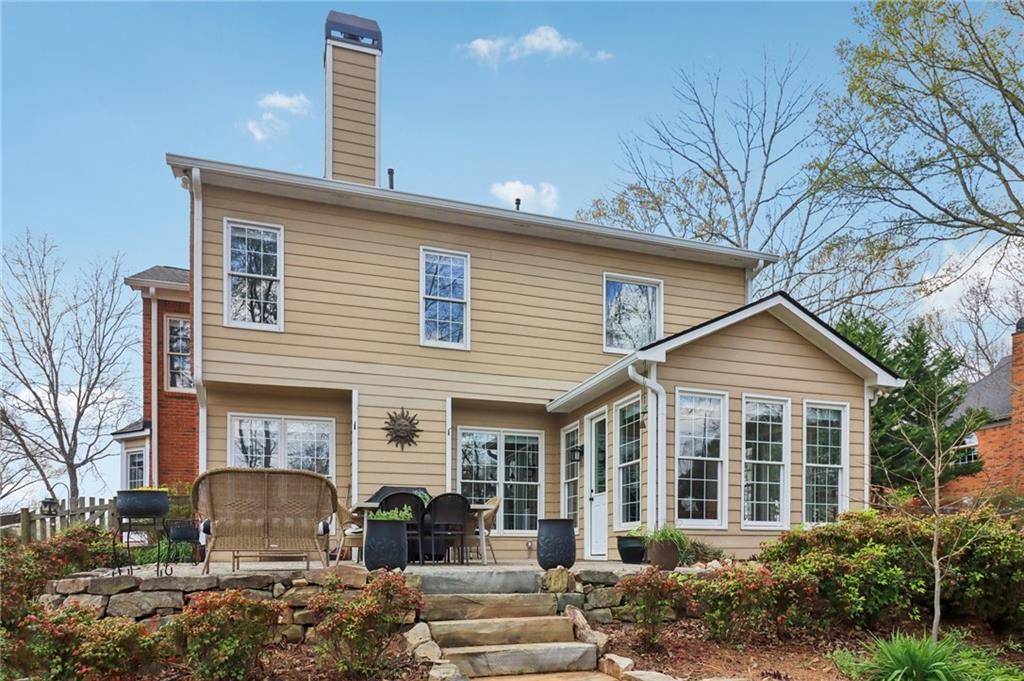 5840 Masters Club Drive Suwanee, GA 30024 - Photo 54 of 72 a front view of a house with garden