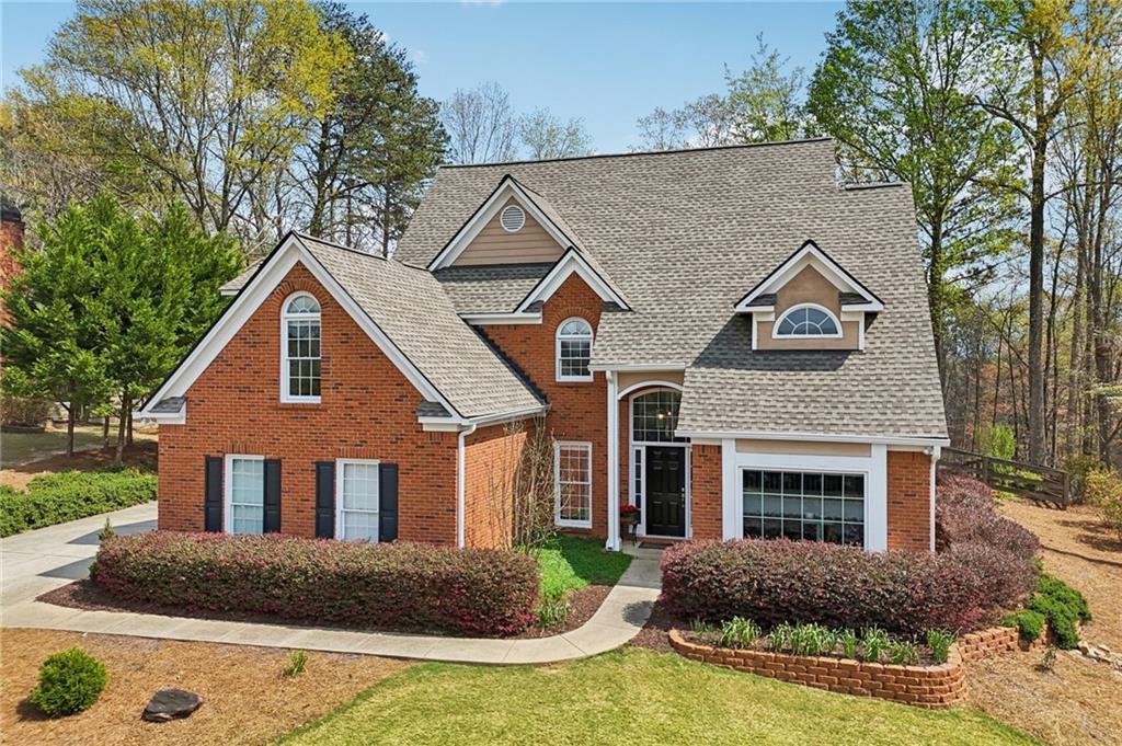 5840 Masters Club Drive Suwanee, GA 30024 - Photo 57 of 72 a front view of a house with yard and parking