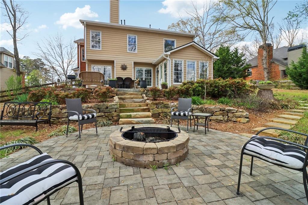 5840 Masters Club Drive Suwanee, GA 30024 - Photo 6 of 72 a view of a patio with dining table and chairs and potted plants