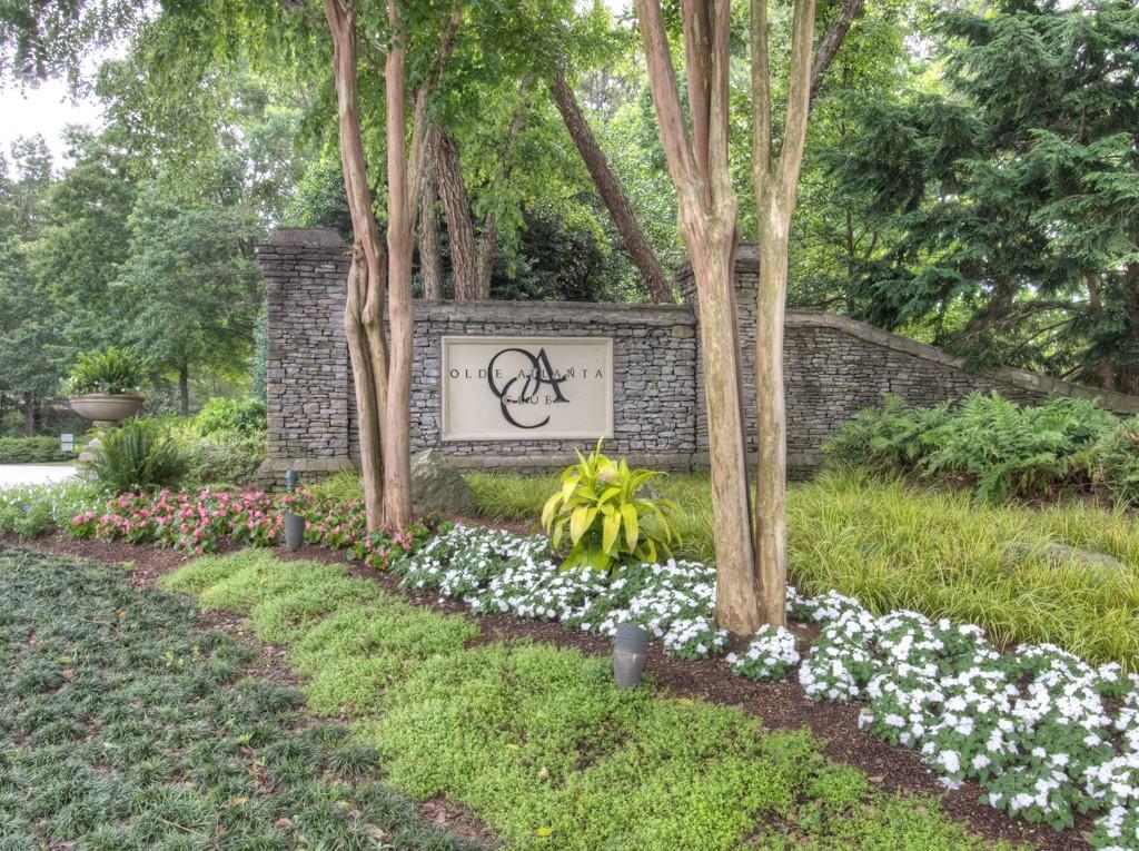 5840 Masters Club Drive Suwanee, GA 30024 - Photo 68 of 72 a view of a street sign under a large tree