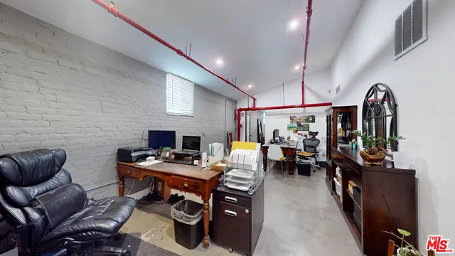 a living room with lots of furniture and gym equipment