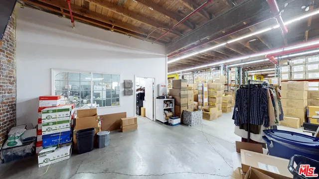 a living room with lots of furniture and a book shelf