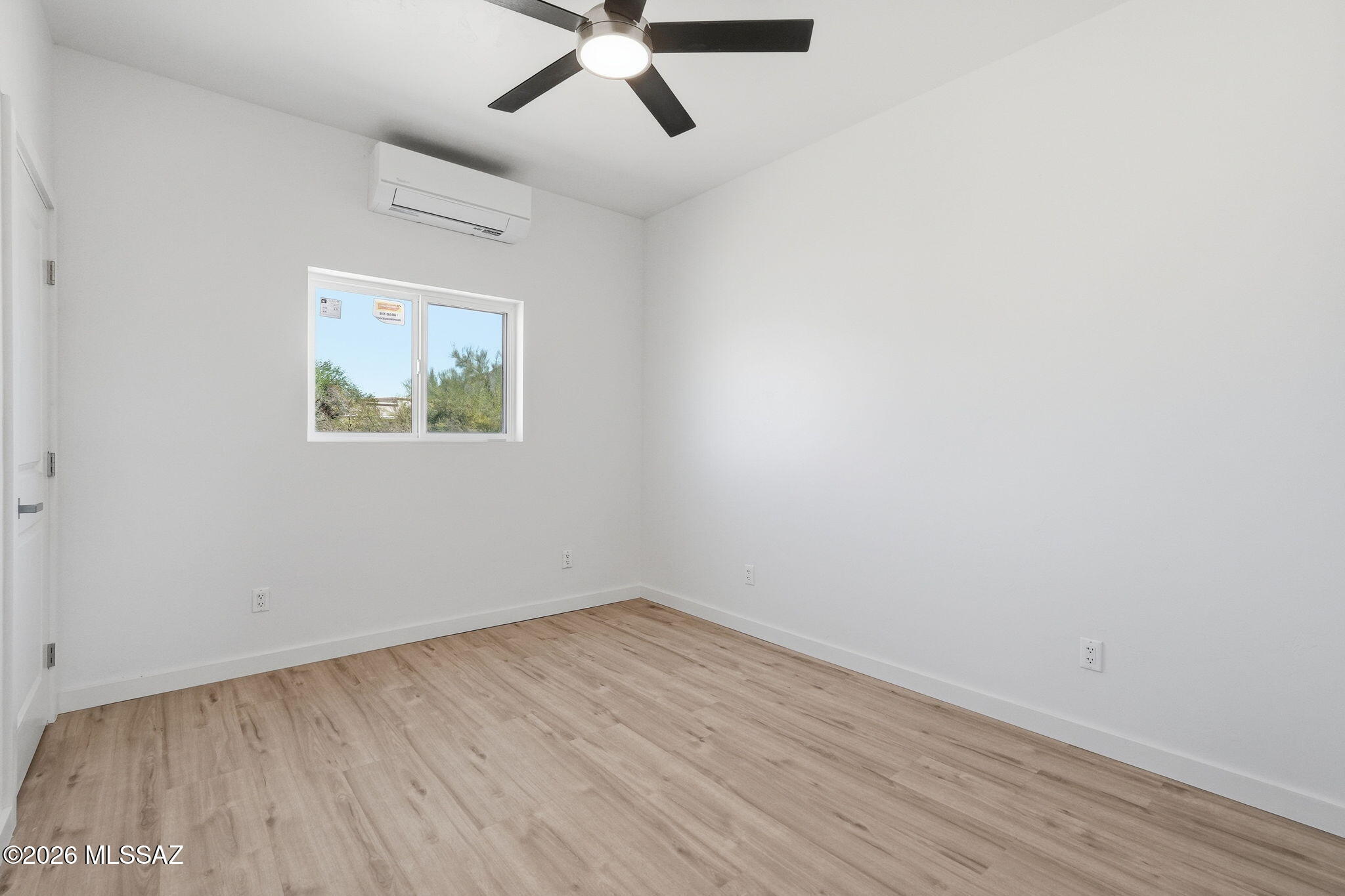 950 West Ina Road Tucson, AZ 85704 - Photo 42 of 54 an empty room with wooden floor and ceiling fan