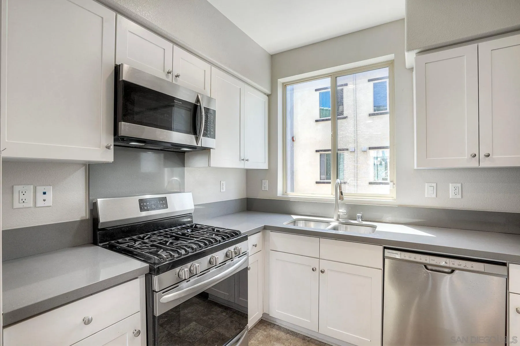 8850 Olive Lane, Unit 7 Santee, CA 92071 - Photo 7 of 27 a kitchen with stainless steel appliances white cabinets and a stove top oven