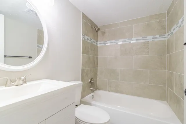 a bathroom with a bathtub and a sink