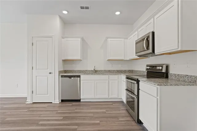 a kitchen with stainless steel appliances granite countertop a stove and a sink