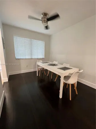 a view of a dining room with furniture and window