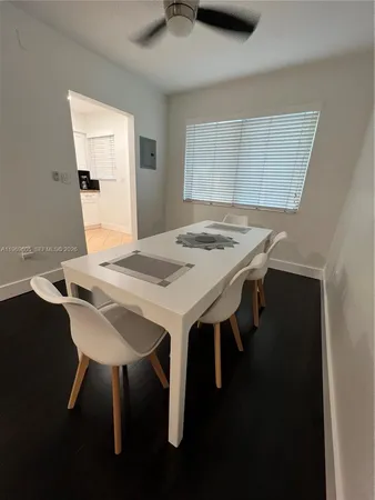 a kitchen with a refrigerator and white cabinets