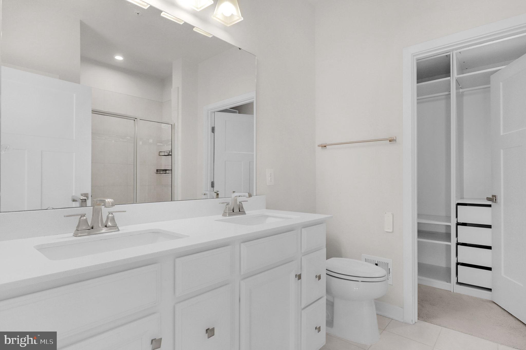 6129 Dock Street Frederick, MD 21703 - Photo 16 of 33 a bathroom with a toilet a sink and mirror