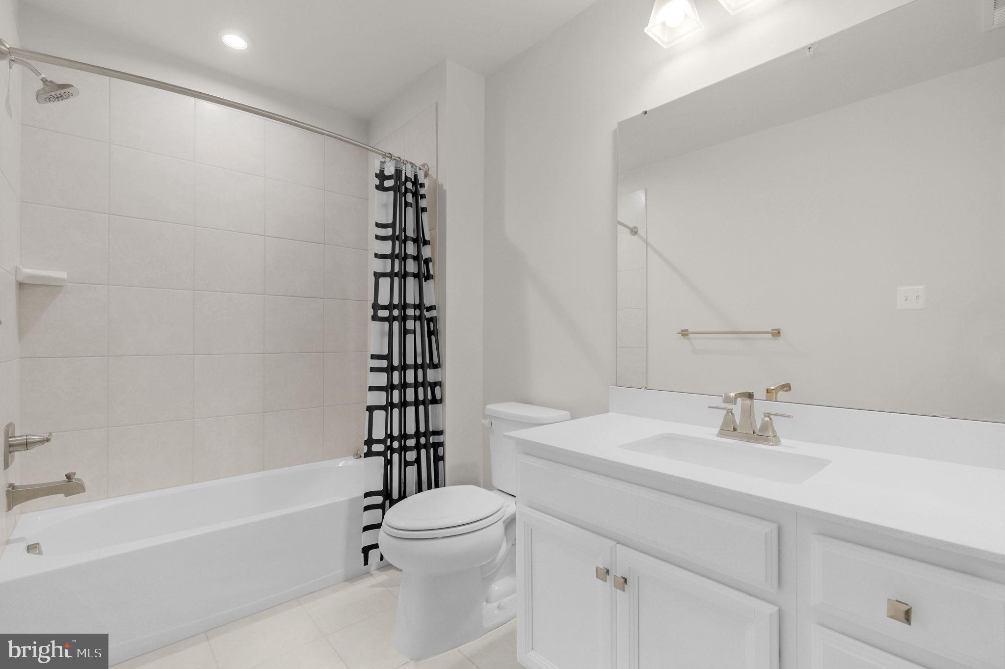 6129 Dock Street Frederick, MD 21703 - Photo 20 of 33 a bathroom with a sink a toilet and shower