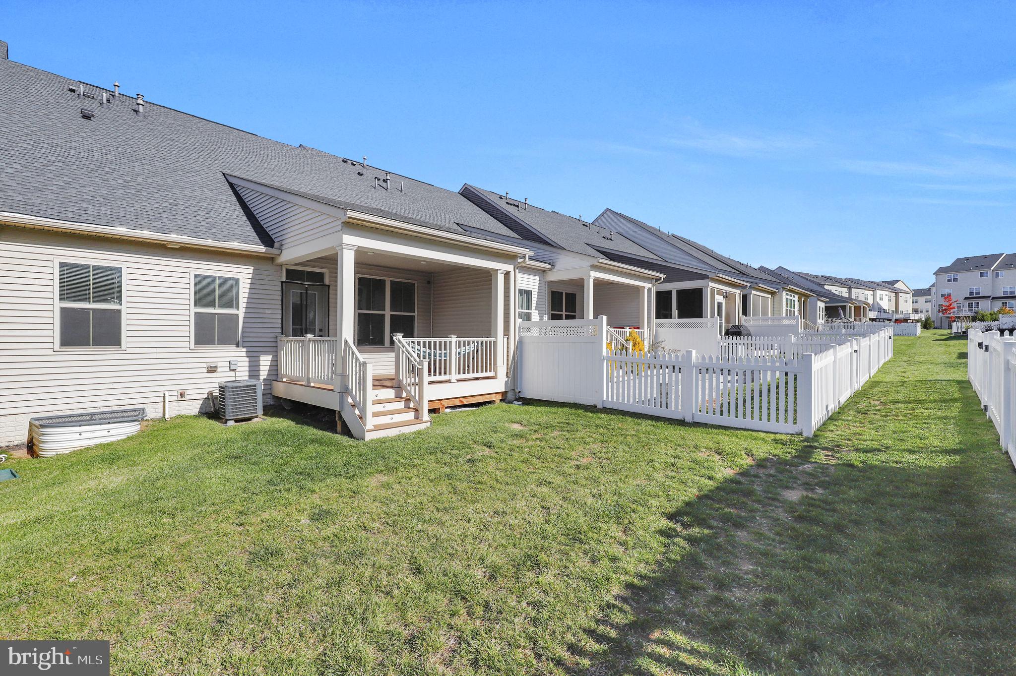 6129 Dock Street Frederick, MD 21703 - Photo 30 of 33 a view of a house with a backyard porch and wooden fence