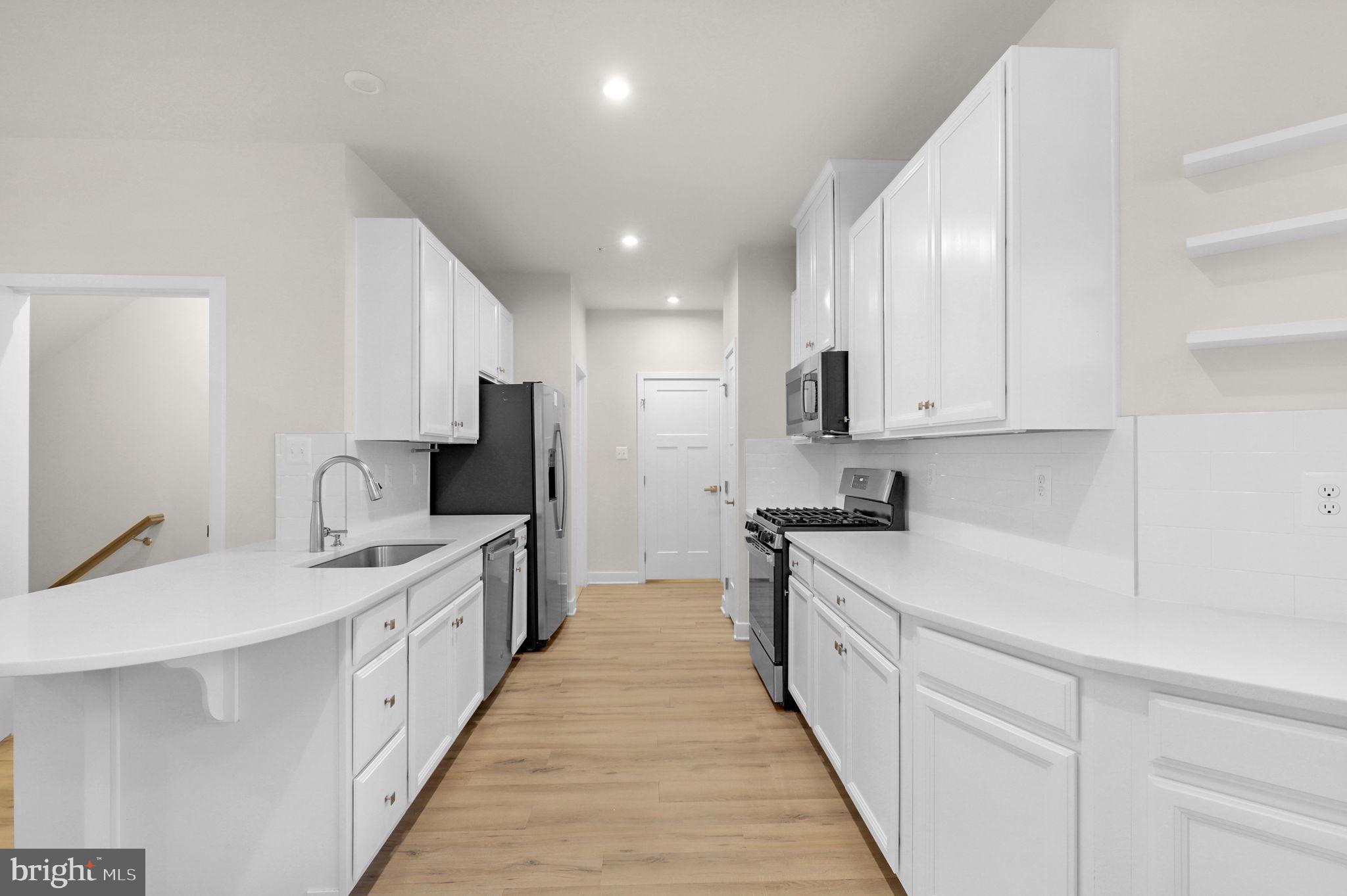 6129 Dock Street Frederick, MD 21703 - Photo 5 of 33 a large kitchen with stainless steel appliances granite countertop a sink and cabinets