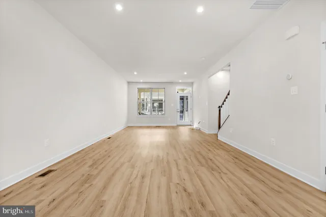 a living room with furniture wooden floor and a flat screen tv