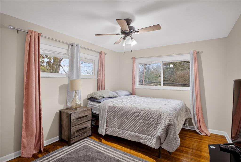 6361 Leechburg Road Verona, PA 15147 - Photo 12 of 26 a bedroom with a bed and wooden floor