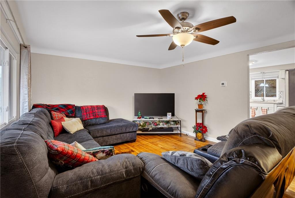 6361 Leechburg Road Verona, PA 15147 - Photo 4 of 26 a living room with furniture and a flat screen tv