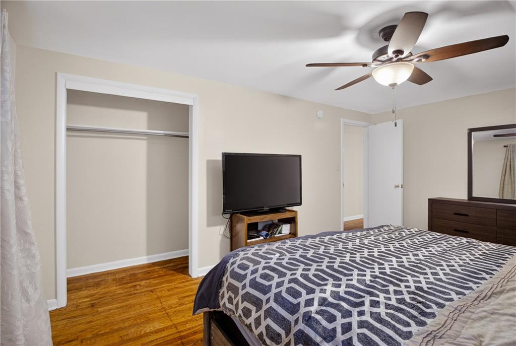 6361 Leechburg Road Verona, PA 15147 - Photo 9 of 26 a bedroom with a bed and a flat tv screen on a dresser