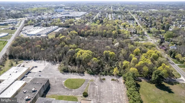 an aerial view of a residential houses with outdoor space
