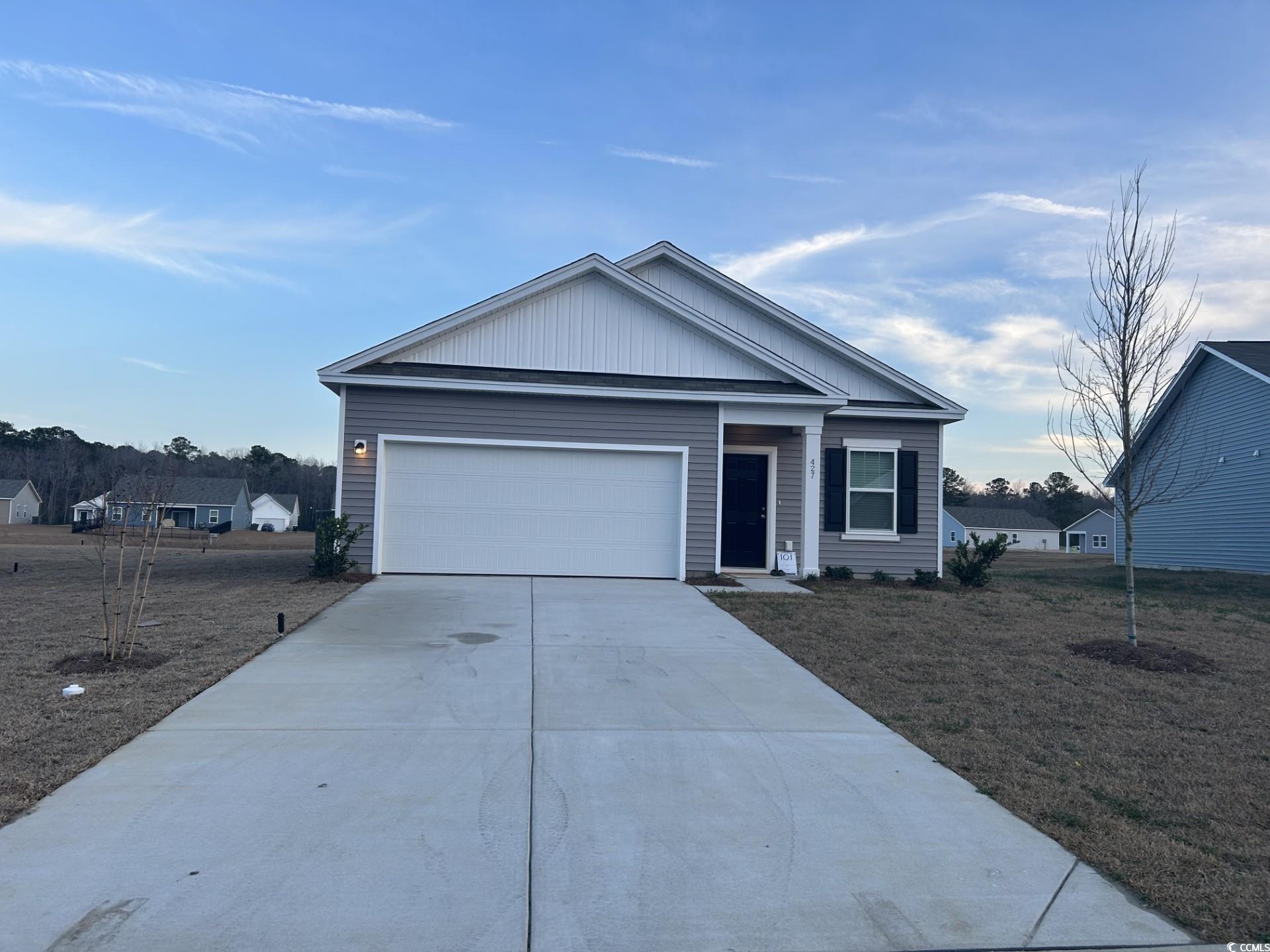 Single story home with concrete driveway, a garage, and a front yard