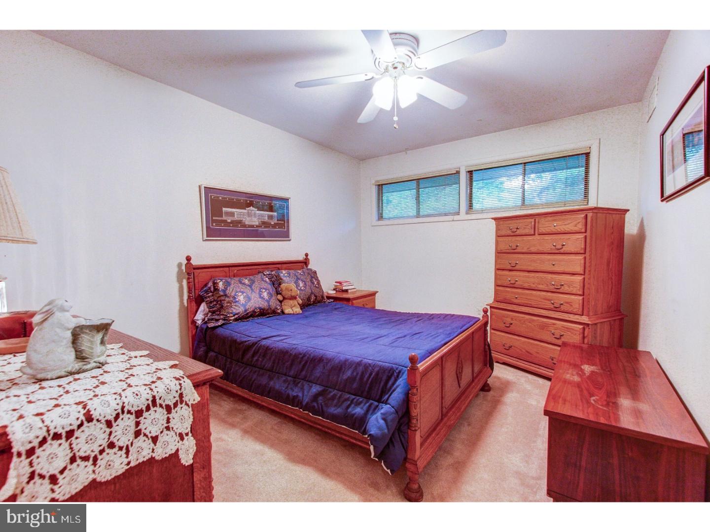 1008 Delene Road Rydal, PA 19046 - Photo 14 of 24 a bedroom with a large bed and a chandelier