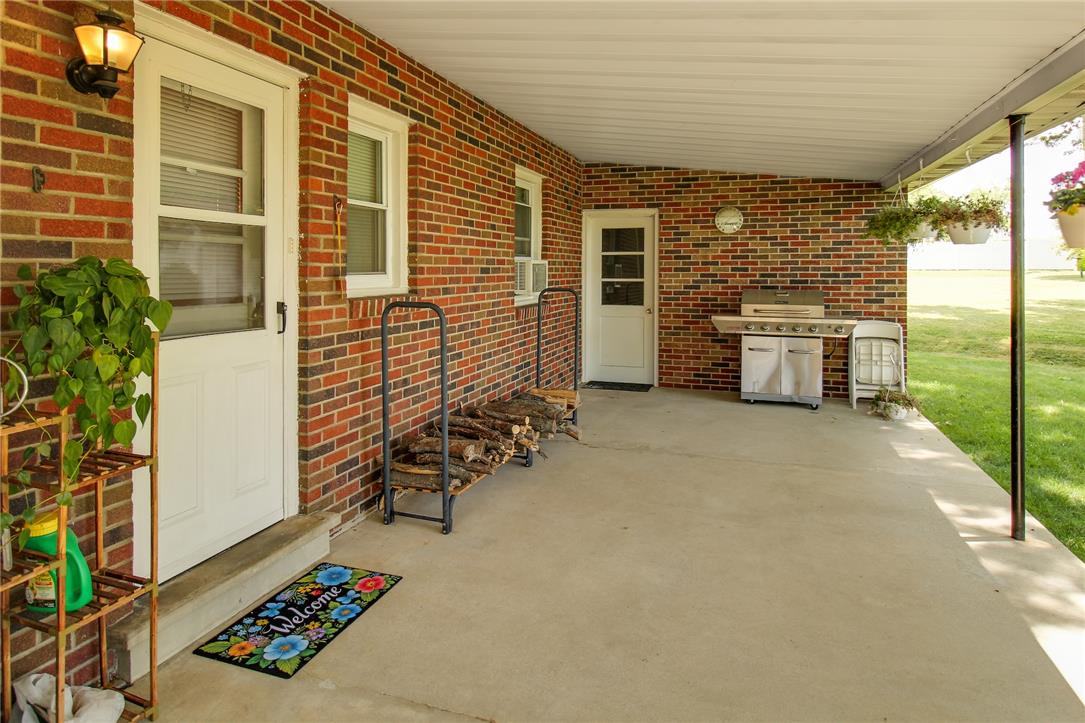 1256 Ridge Avenue Whitehall, PA 18052 - Photo 8 of 43 An inviting covered patio with exposed brick walls, perfect for outdoor entertaining.