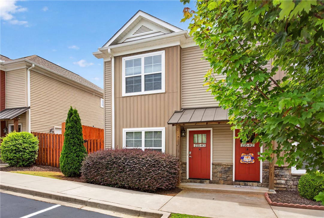A welcoming facade showcases durable siding, stone accents, and a tidy landscape with mature plantings.
