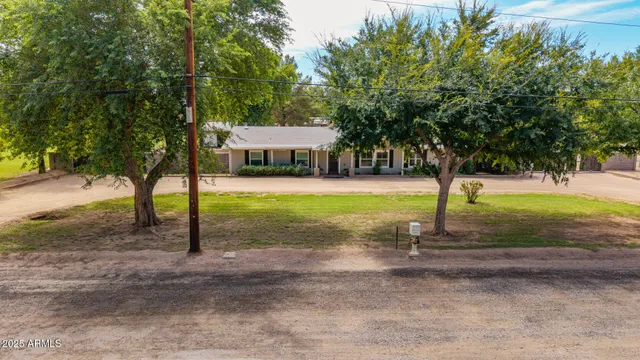 an aerial view of a house with a yard