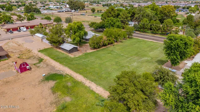 an aerial view of a house with a garden and yard