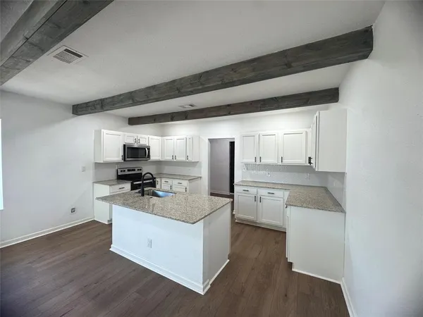 a kitchen with sink refrigerator and stove