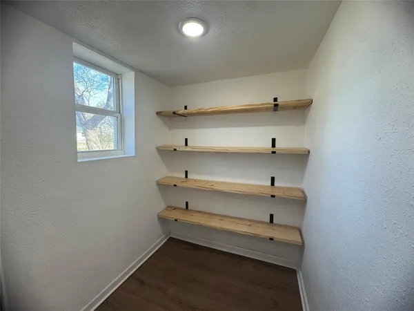 en empty room with windows and ceiling fan
