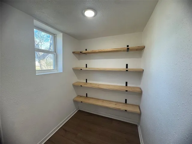 en empty room with windows and ceiling fan