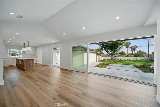 a kitchen with cabinets and wooden floor