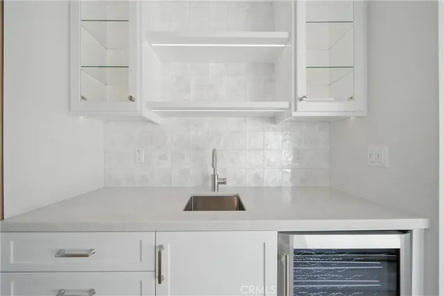 a kitchen with kitchen island a stove a sink and a refrigerator with wooden floor