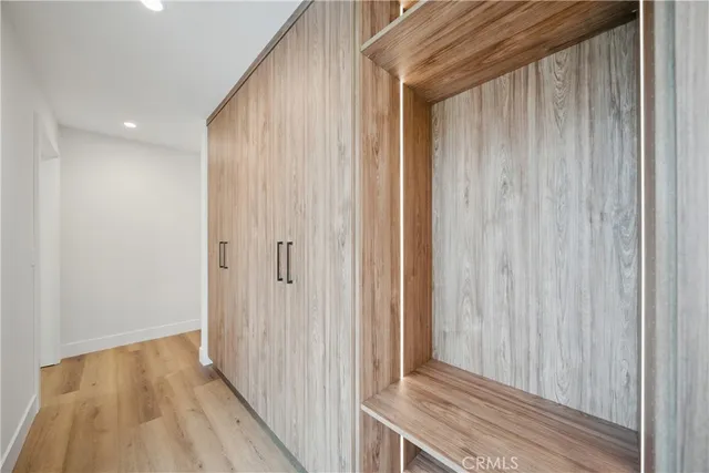 a kitchen with cabinets and a refrigerator